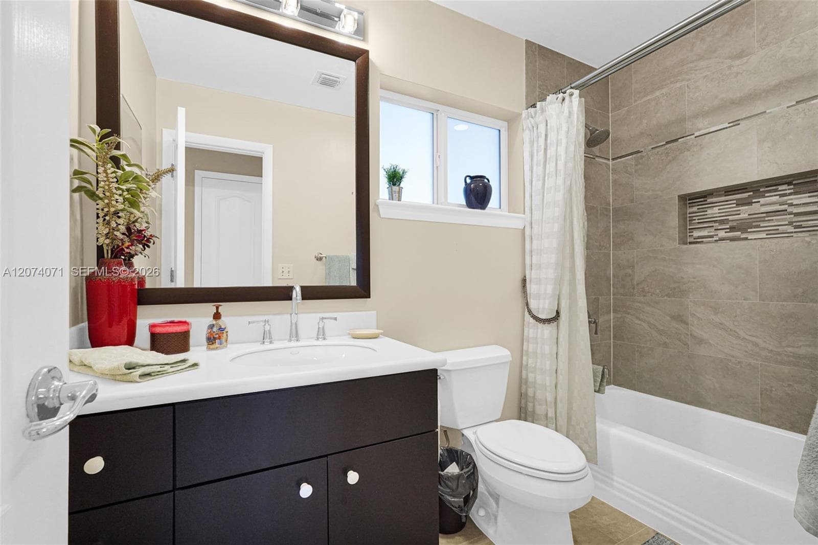 Stylish full bathroom with contemporary finishes and walk-in shower.