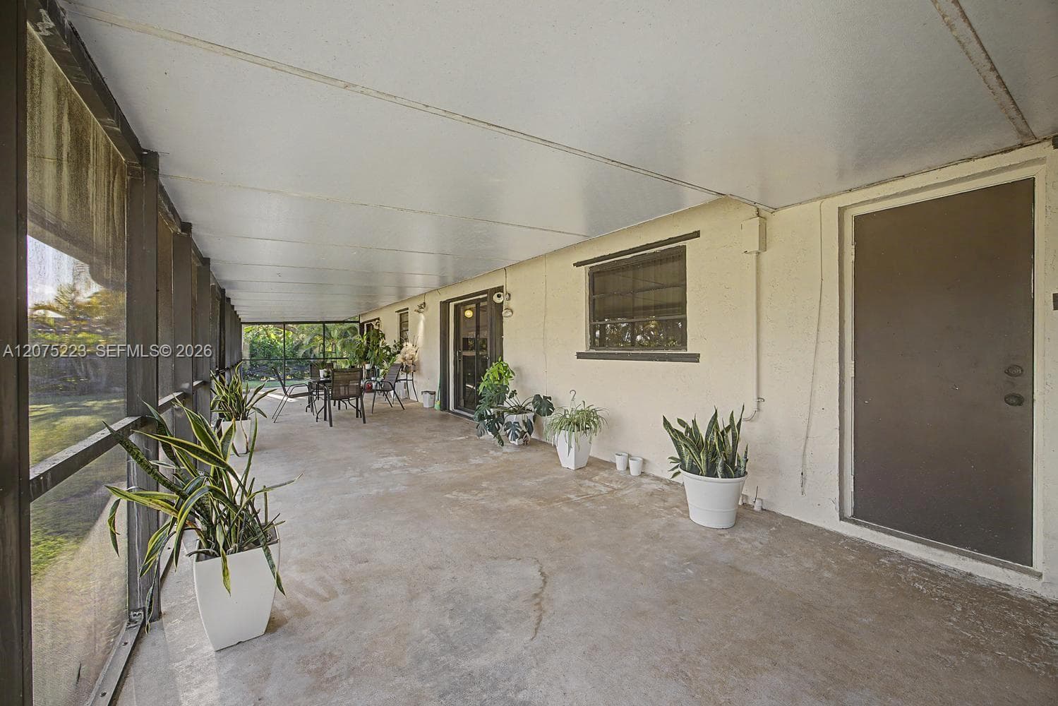 An impressive screened outdoor living area overlooks the expansive backyard, perfect for enjoying the South Florida lifestyle.