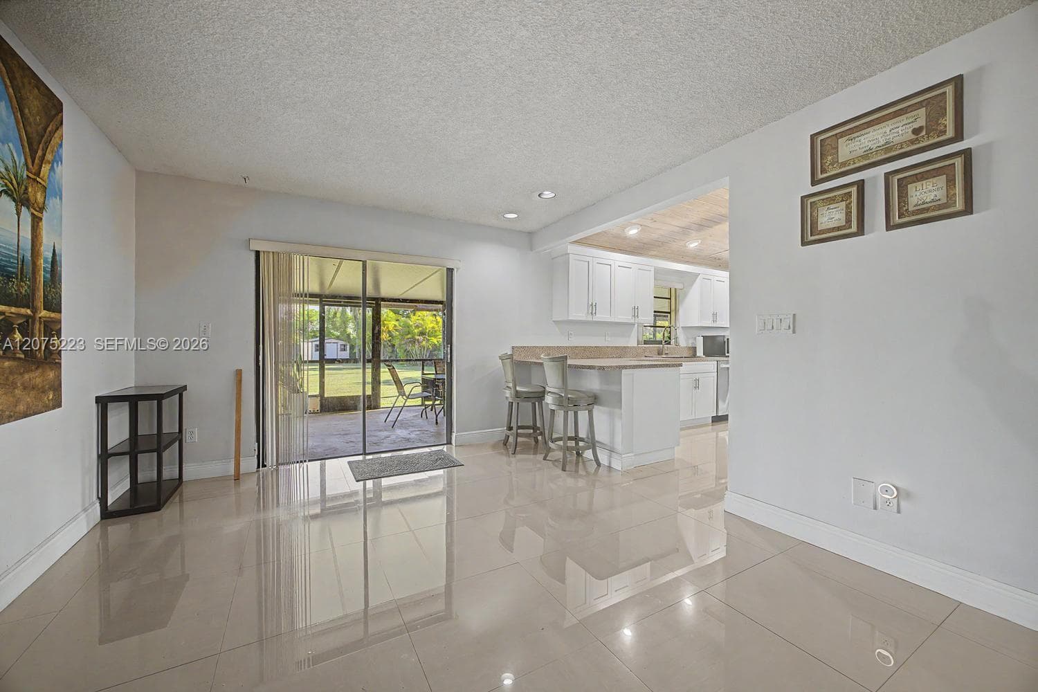 Flexible additional living or dining space with direct access to the screened outdoor area.