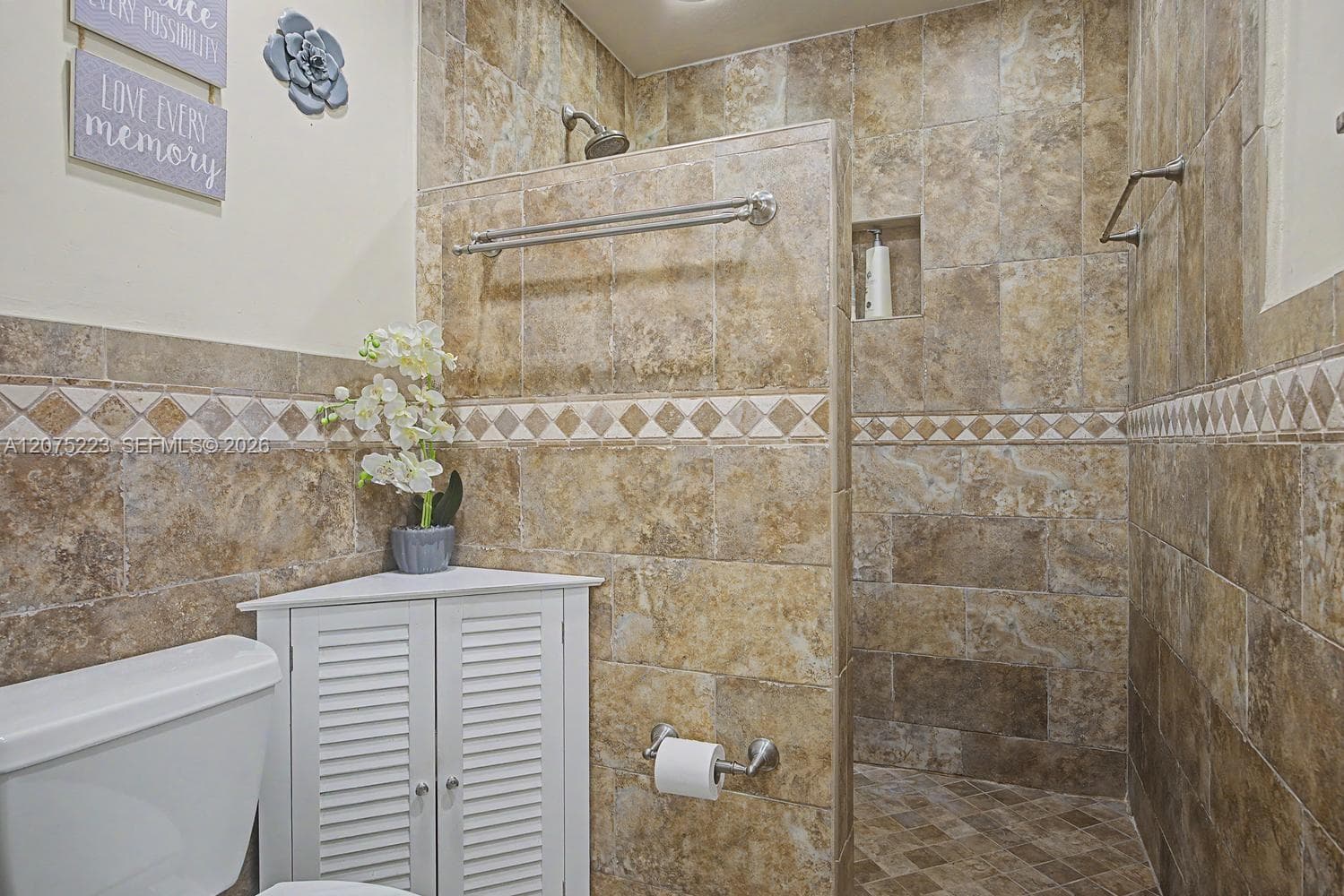 Separate walk-in tiled shower complements the soaking tub for a spacious primary bath layout.