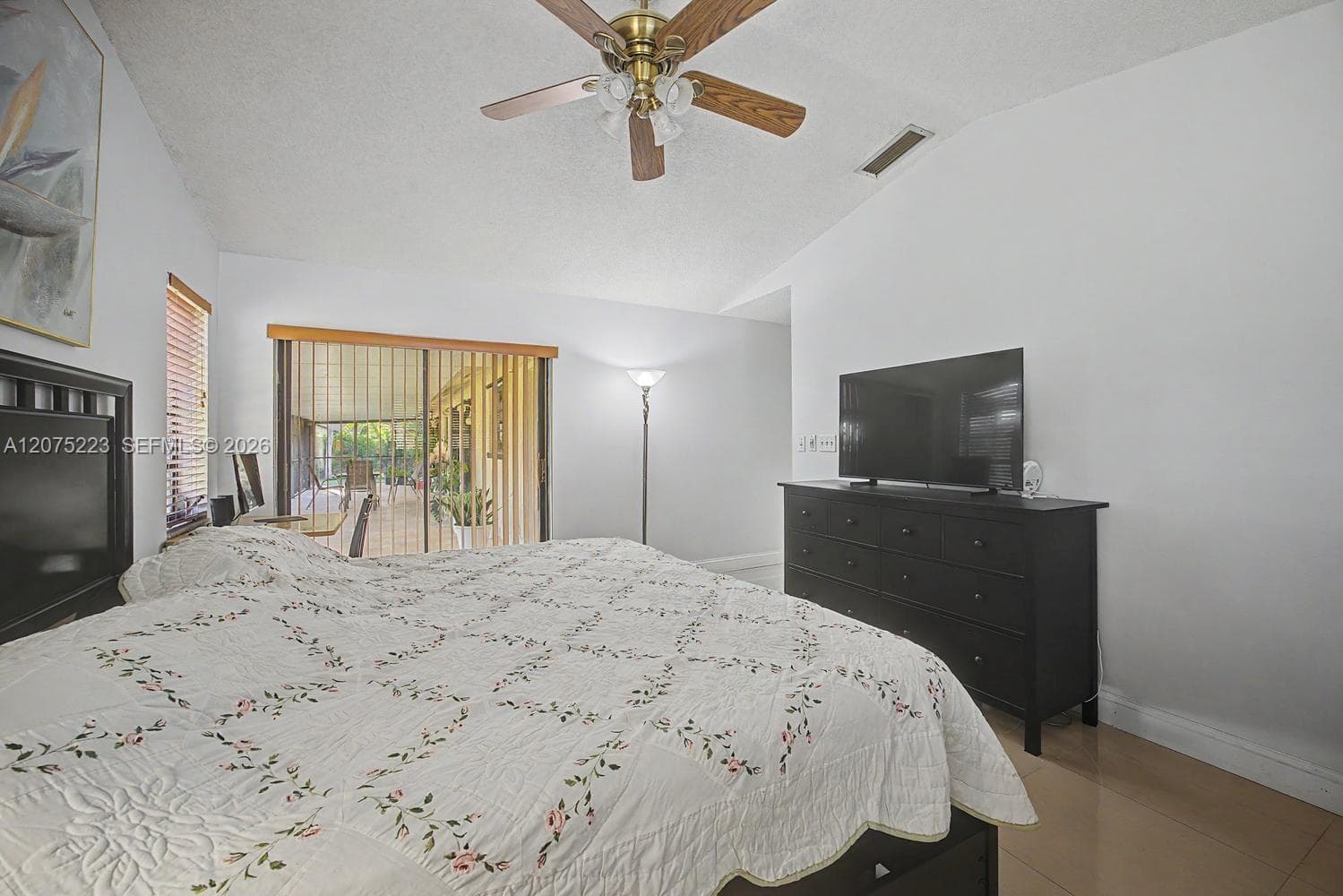 Primary suite offers direct access to the screened porch, extending the living space outdoors.