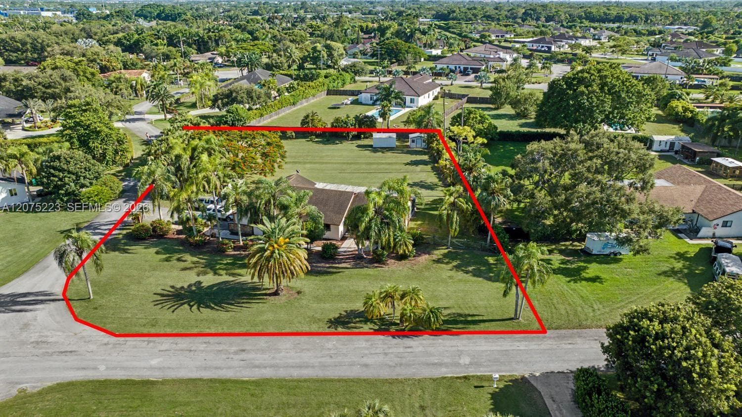 Another aerial perspective showcases the home's generous homesite, large open yard and surrounding residential setting.
