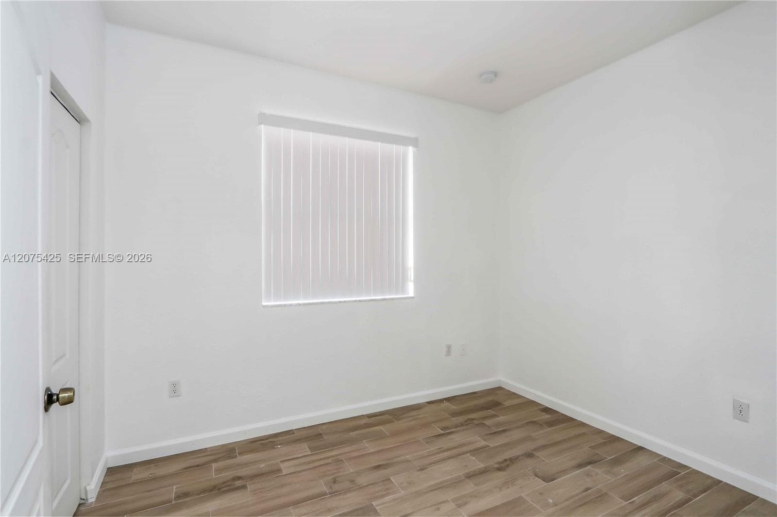 Spacious and well-lit bedroom interior.