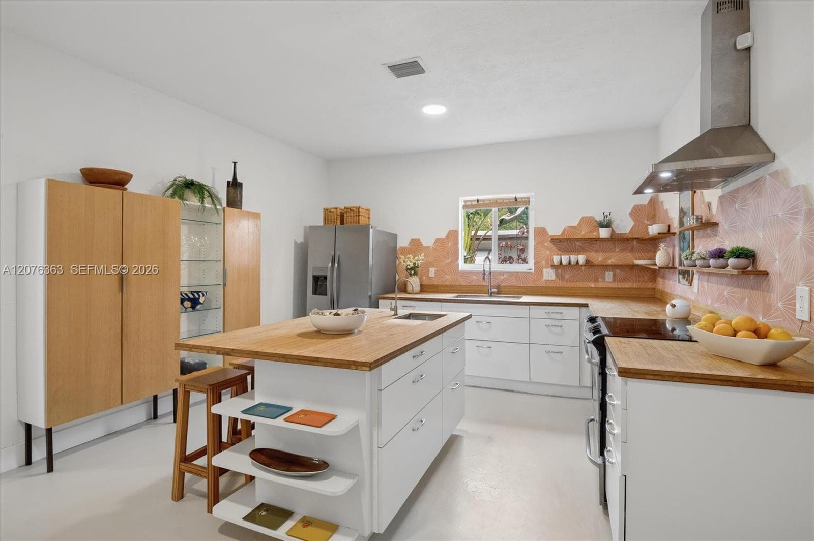 Center Island with prep sink & custom butcher block counters.