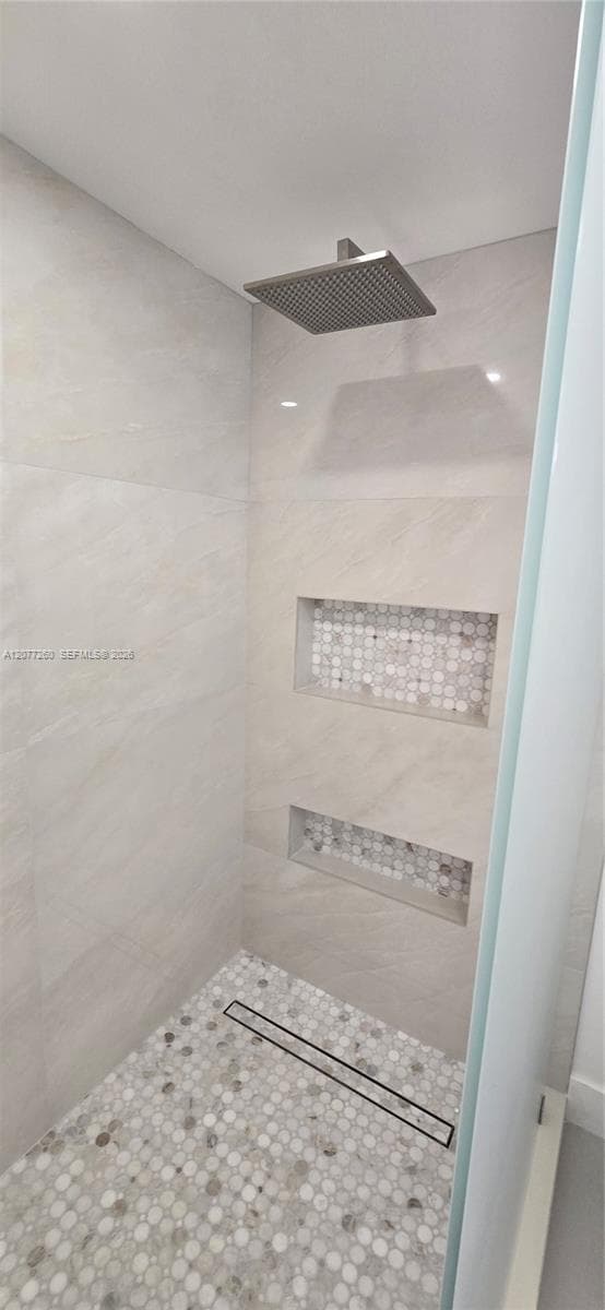 Primary bath shower features rainhead shower, ample niches for bath products and linear shower drain. All new! Neutral and contemporary sufaces and fixtures throughout.