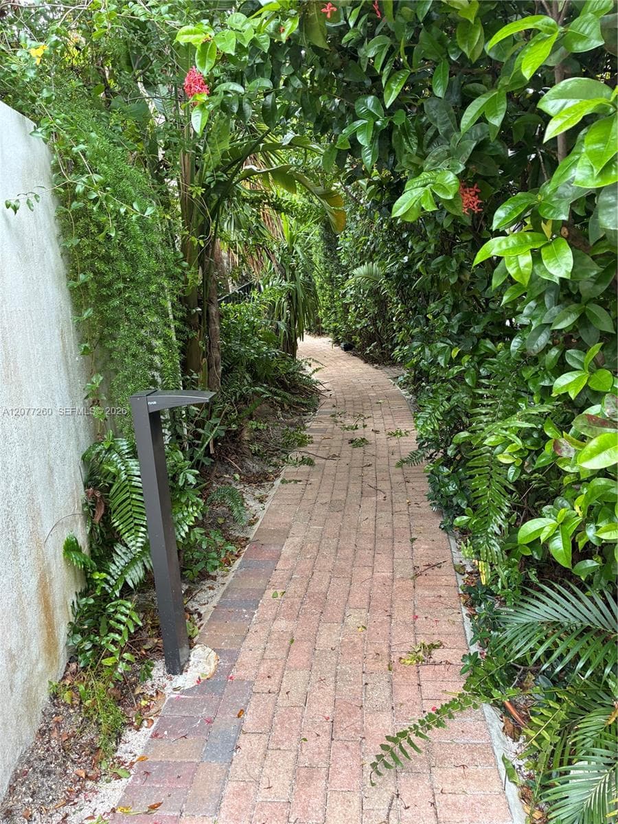 Lighted pathways and lush tropical foliage lead you home.