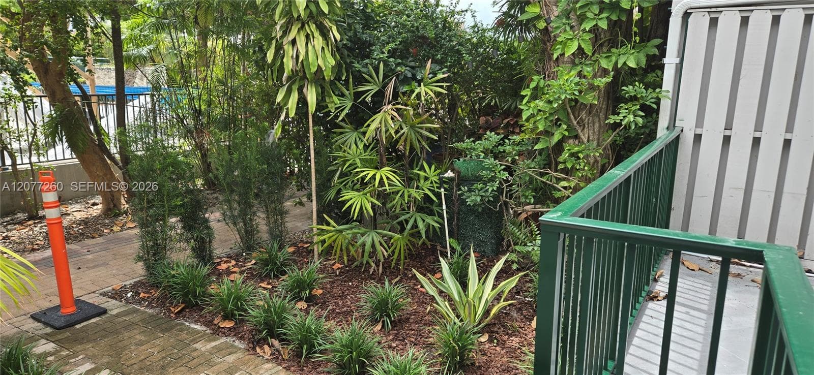 Private patio accessed from kitchen/dining area enhanced with lush tropical landscaping.
