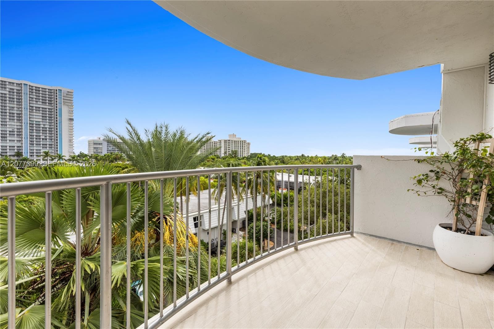 Covered balcony featuring tile flooring and metal railings