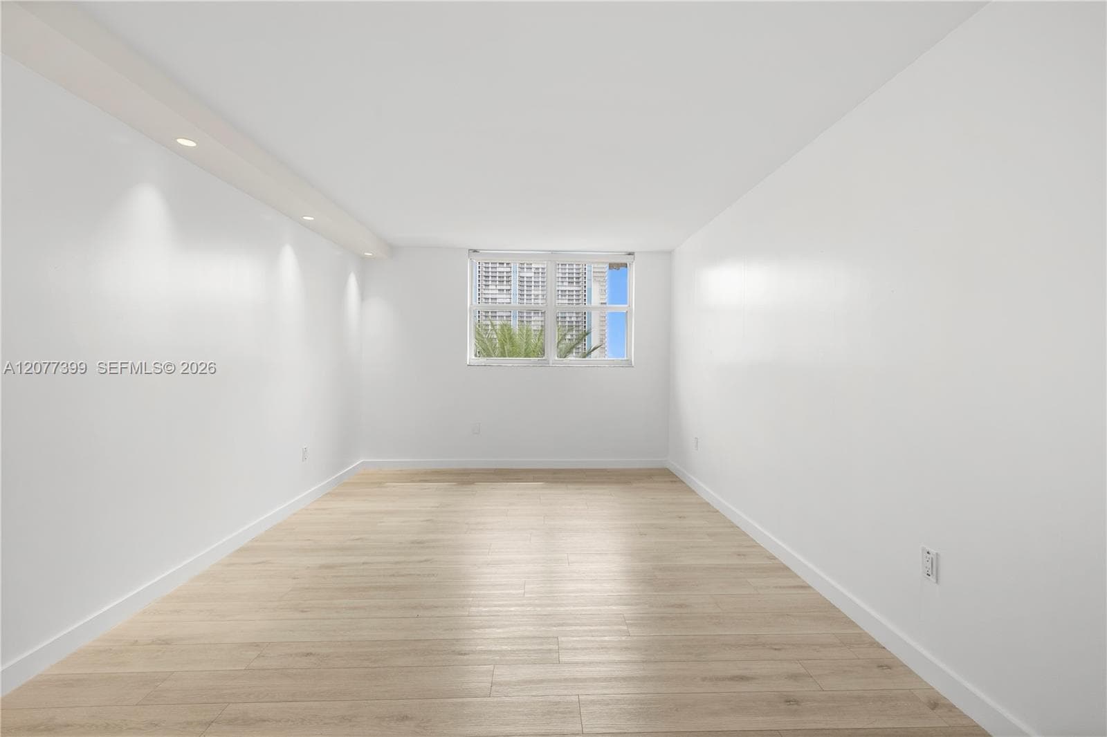 Interior space featuring wood-finish flooring, recessed lighting, and a multi-pane window