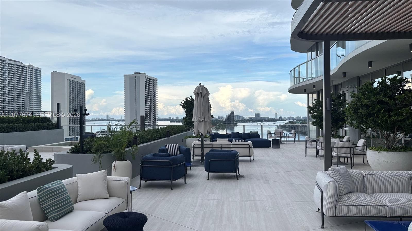 Designer-Furnished Poolside Lounge with Bay Views