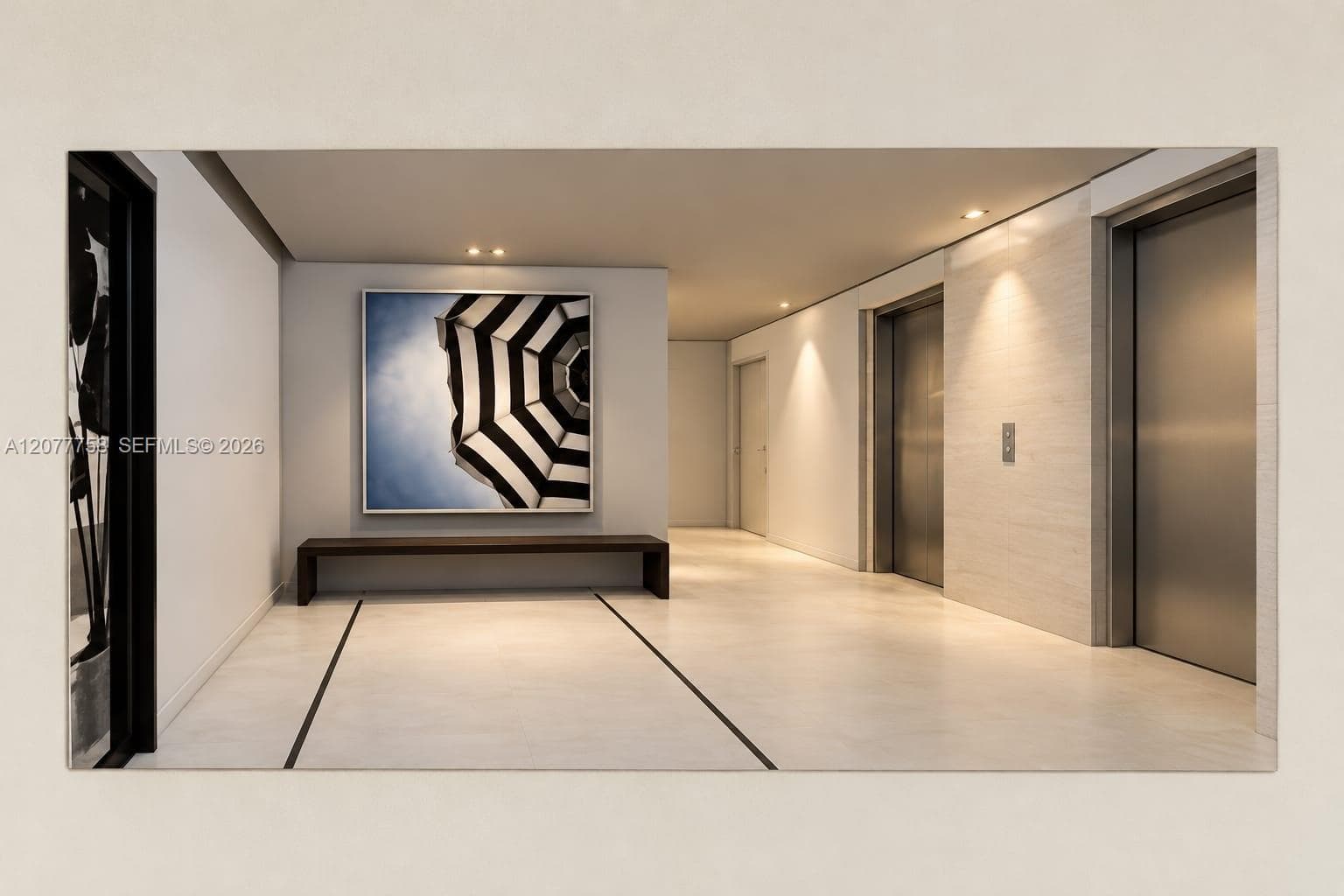 Recessed ceiling lighting, light-toned flooring with dark inlay, and multiple elevator access points