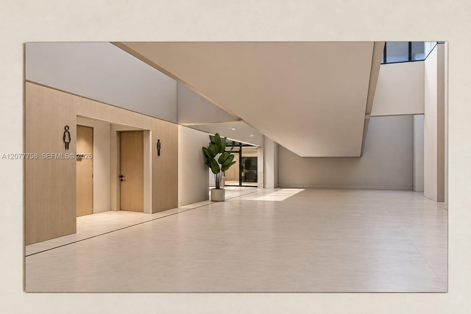 Spacious interior with light-toned tile flooring, light wood-finish wall panels, and high ceilings