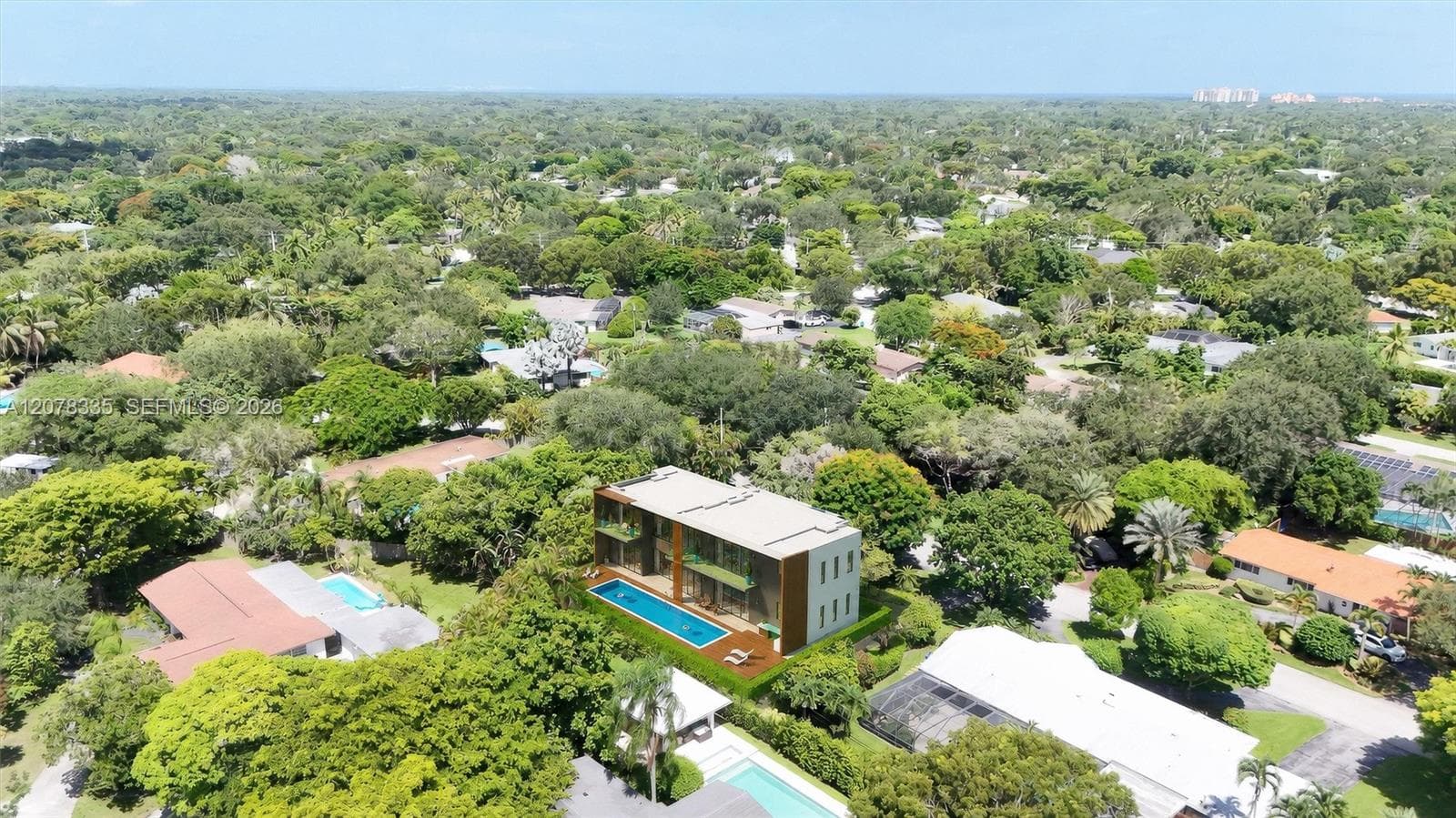 Aerial perspective highlighting the home's location within a lush, established community.