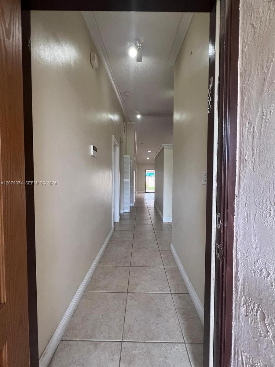 Ceramic tile flooring, neutral wall tones, and recessed ceiling lighting