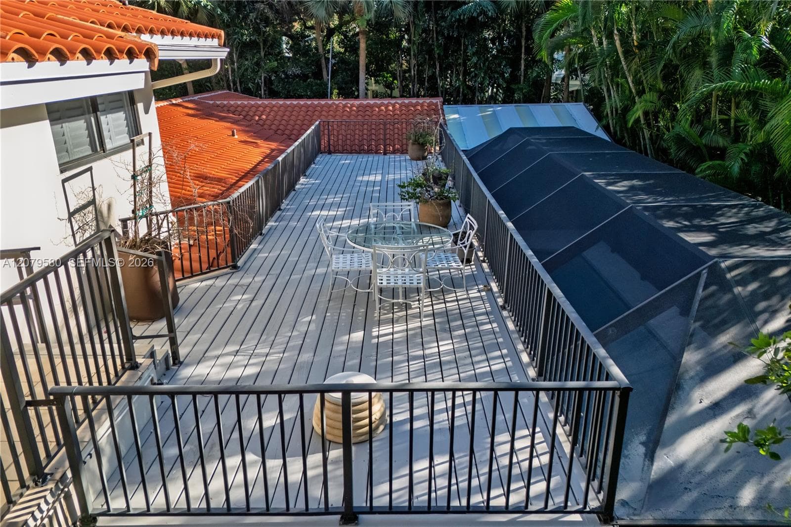 Elevated deck featuring composite planking and black metal railing
