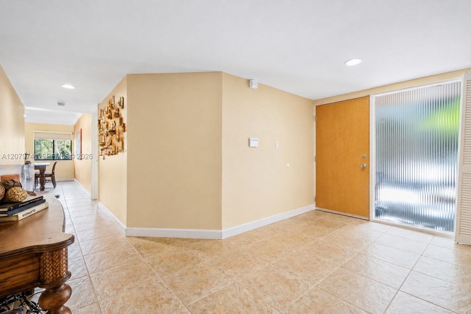 View 2 of the foyer.Glass wall at the entrance make the space bright, welcoming and practical.