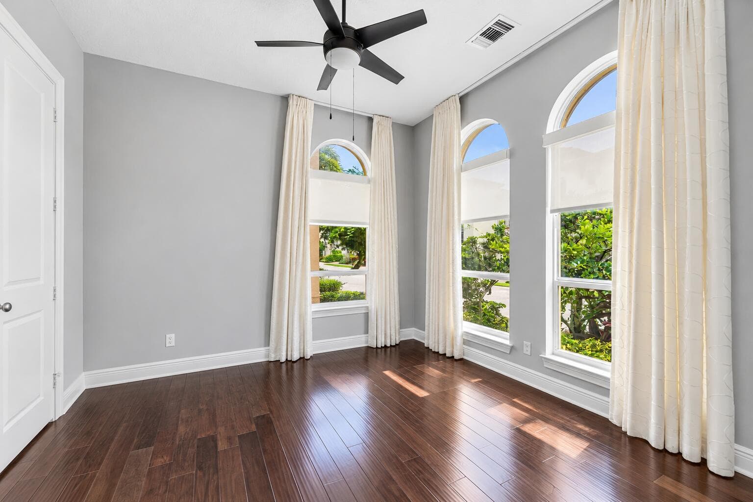 Sunlit Empty Room with Arched Windows