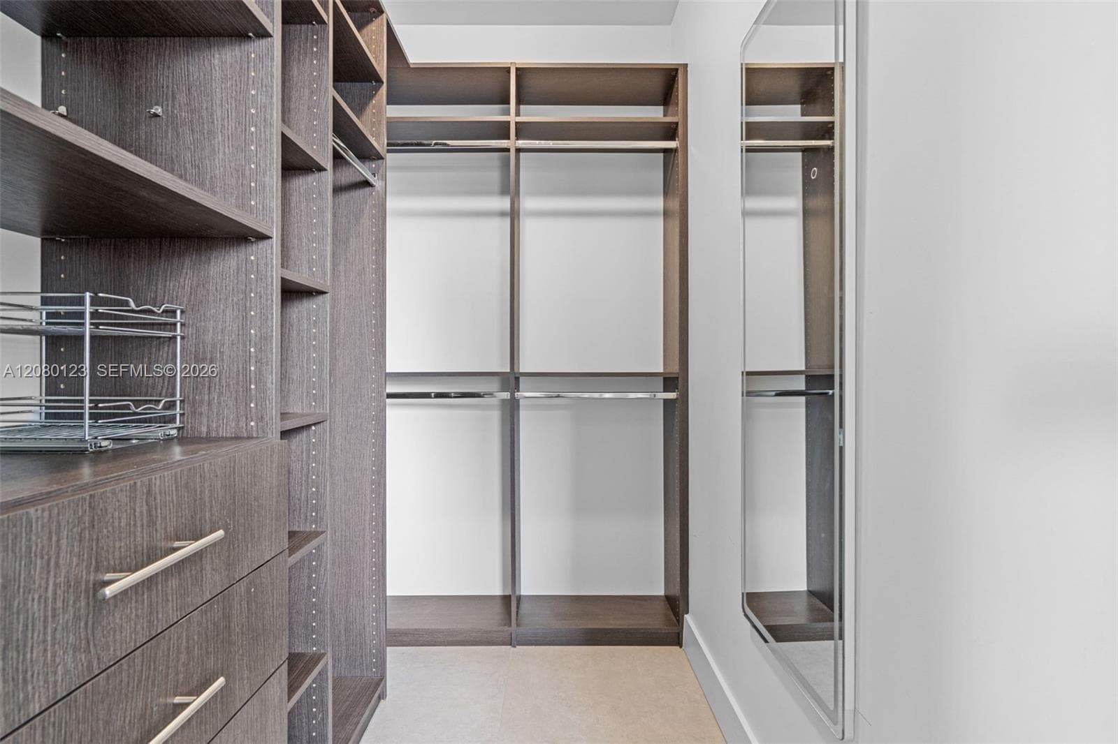 Custom-built walk-in closet with shelving, drawer system, and abundant rod space at PH-5209.