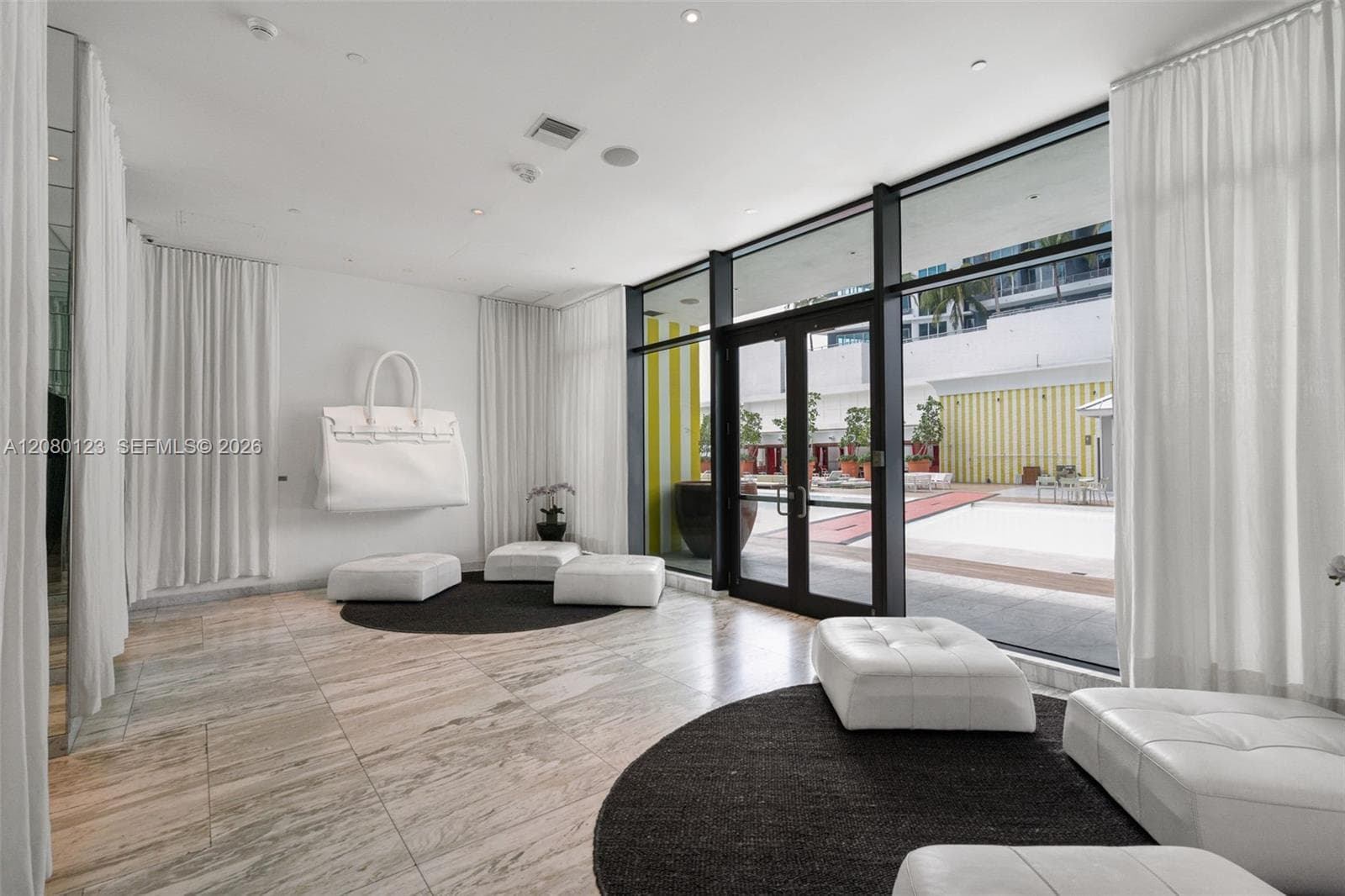 Designer-curated lobby with art-forward installations at SLS Brickell Dua's resident entrance.
