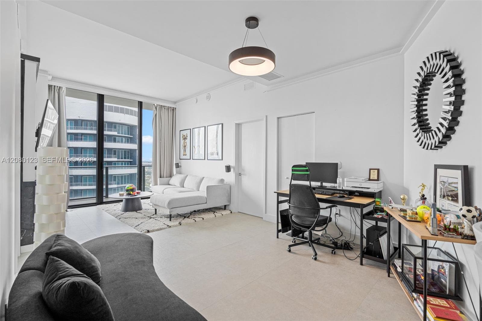 Open-concept floor plan with integrated home office and designer art wall at SLS Brickell Dua PH-5209.