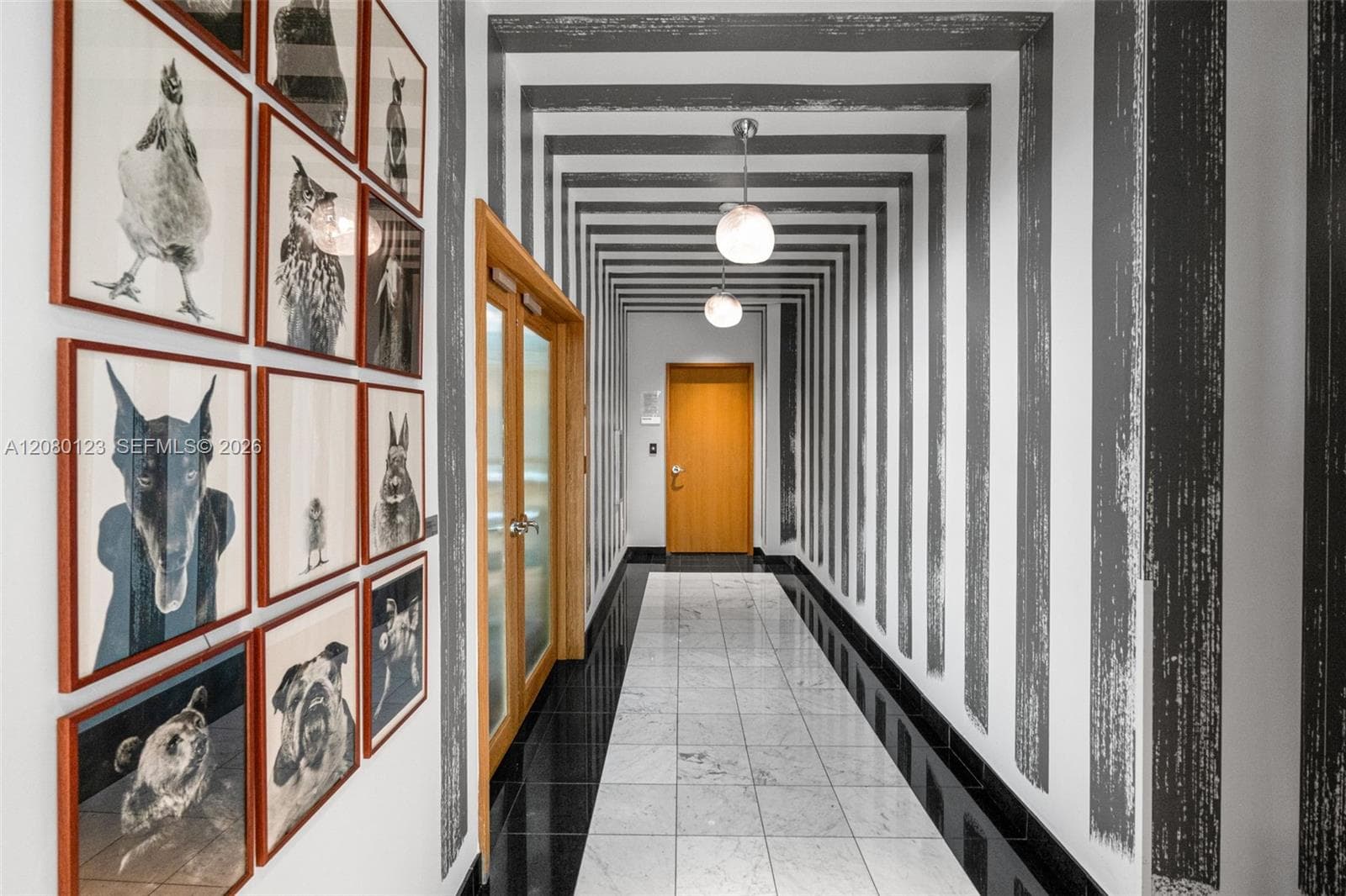 Curated resident corridor with photographic art installations at SLS Brickell Dua.