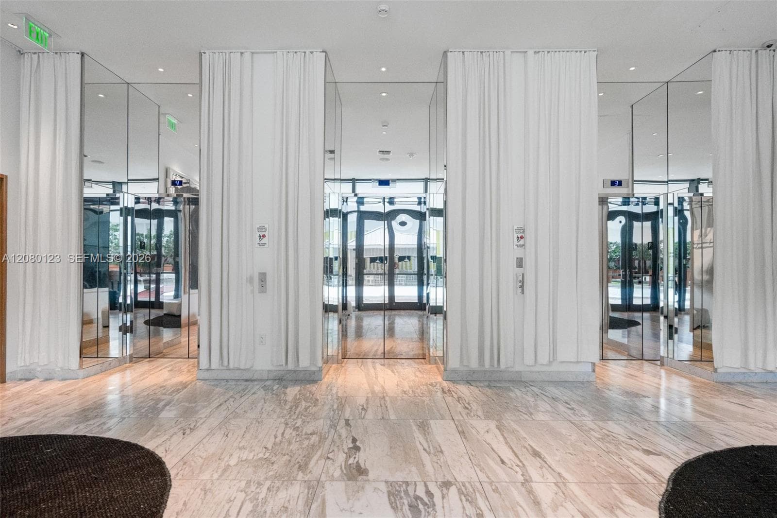 Mirrored elevator lobby at SLS Brickell Dua - 24/7 attended access for residents.