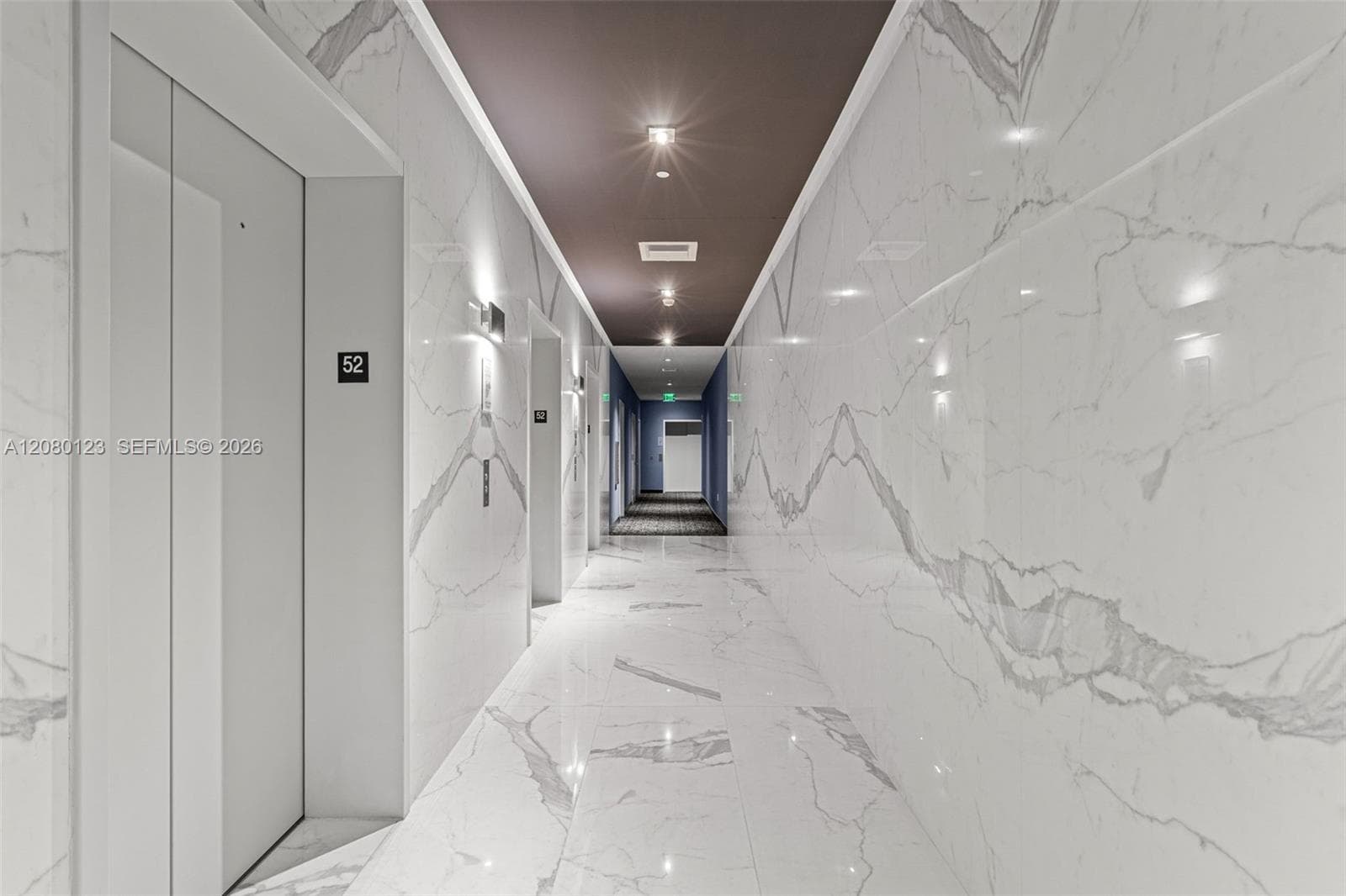 Polished marble corridor on the 52nd floor - hotel-style penthouse arrival experience at SLS Brickell Dua.