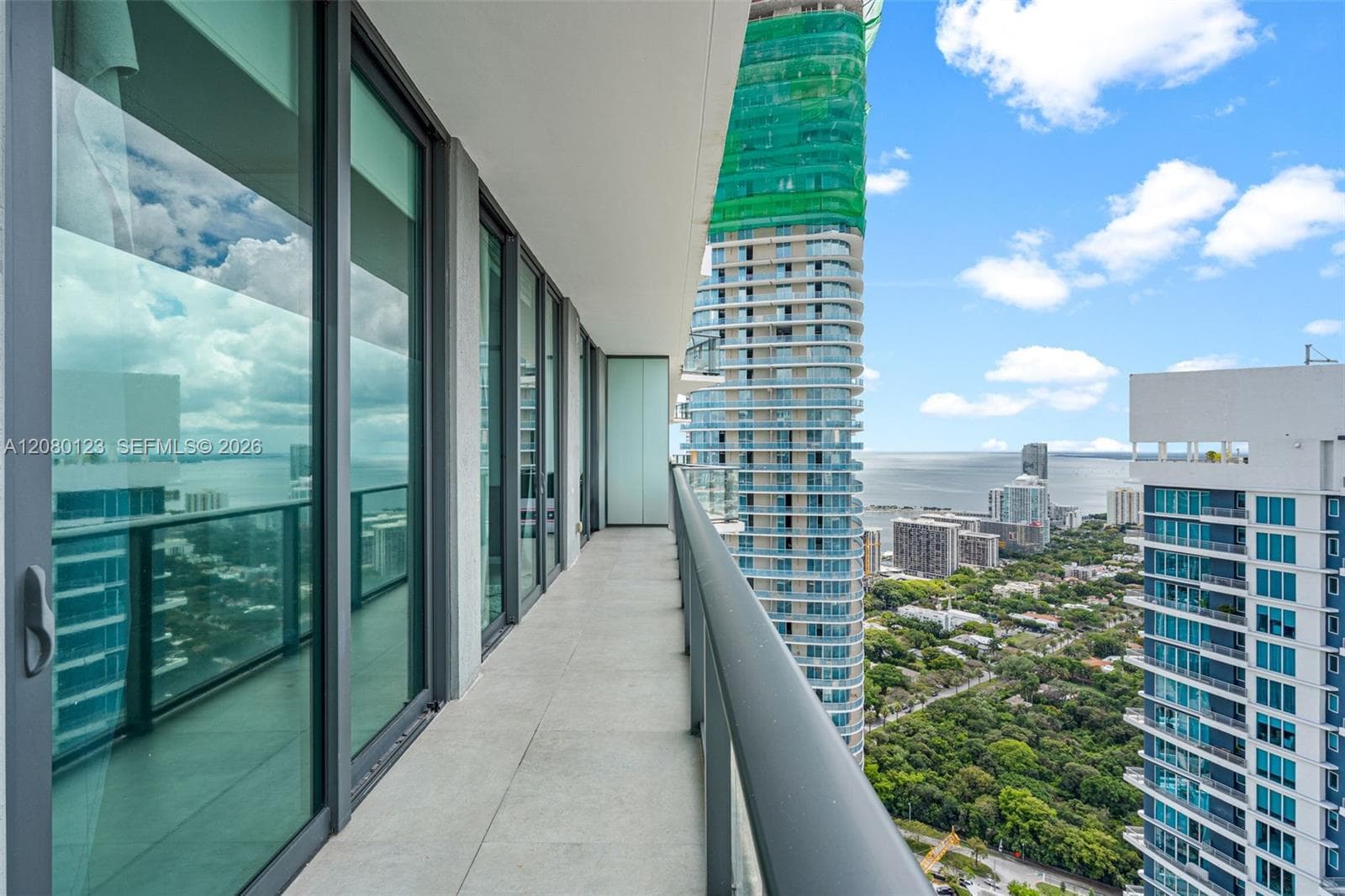 Panoramic ocean and skyline view from the PH-5209 terrace - rare 52nd-floor exposure at SLS Brickell Dua.