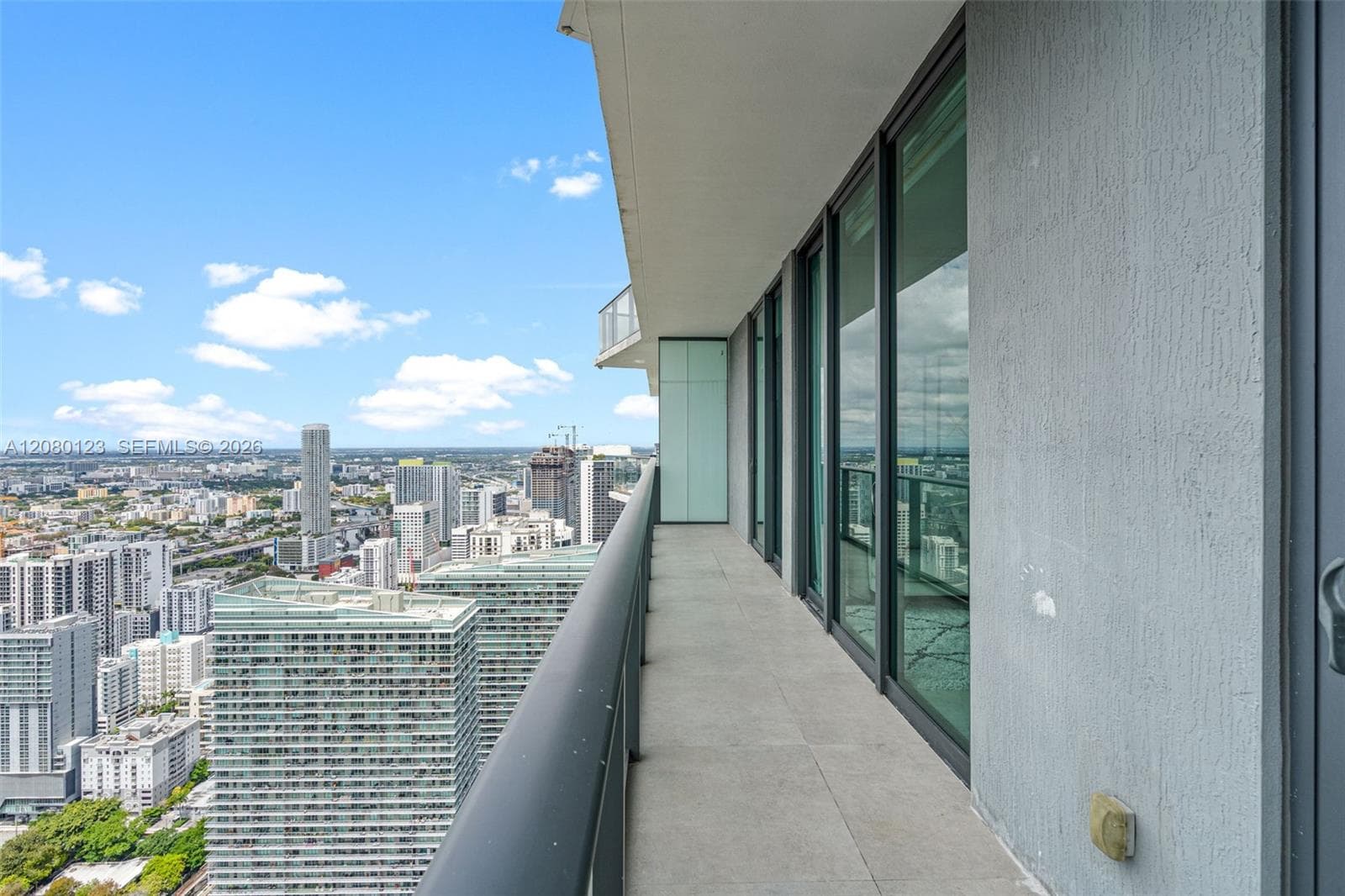 Wraparound terrace at PH-5209 with sweeping views of the Brickell skyline and Biscayne Bay.