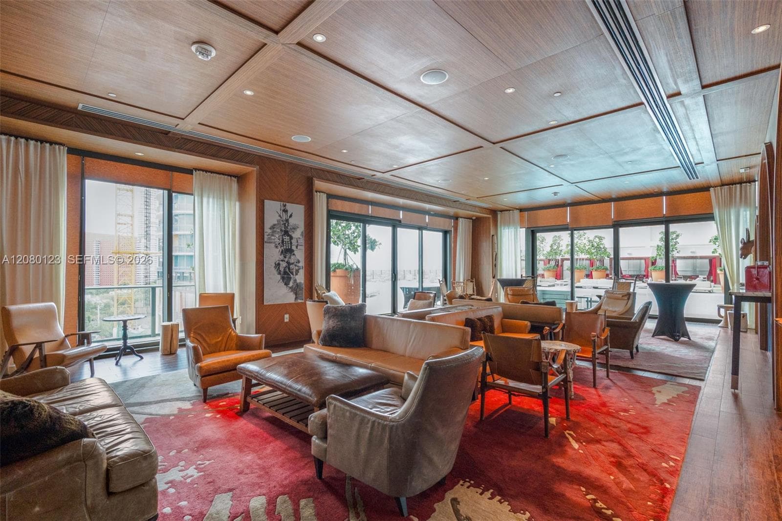 Resident lounge with cocktail seating, designer interiors, and skyline views at SLS Brickell Dua.