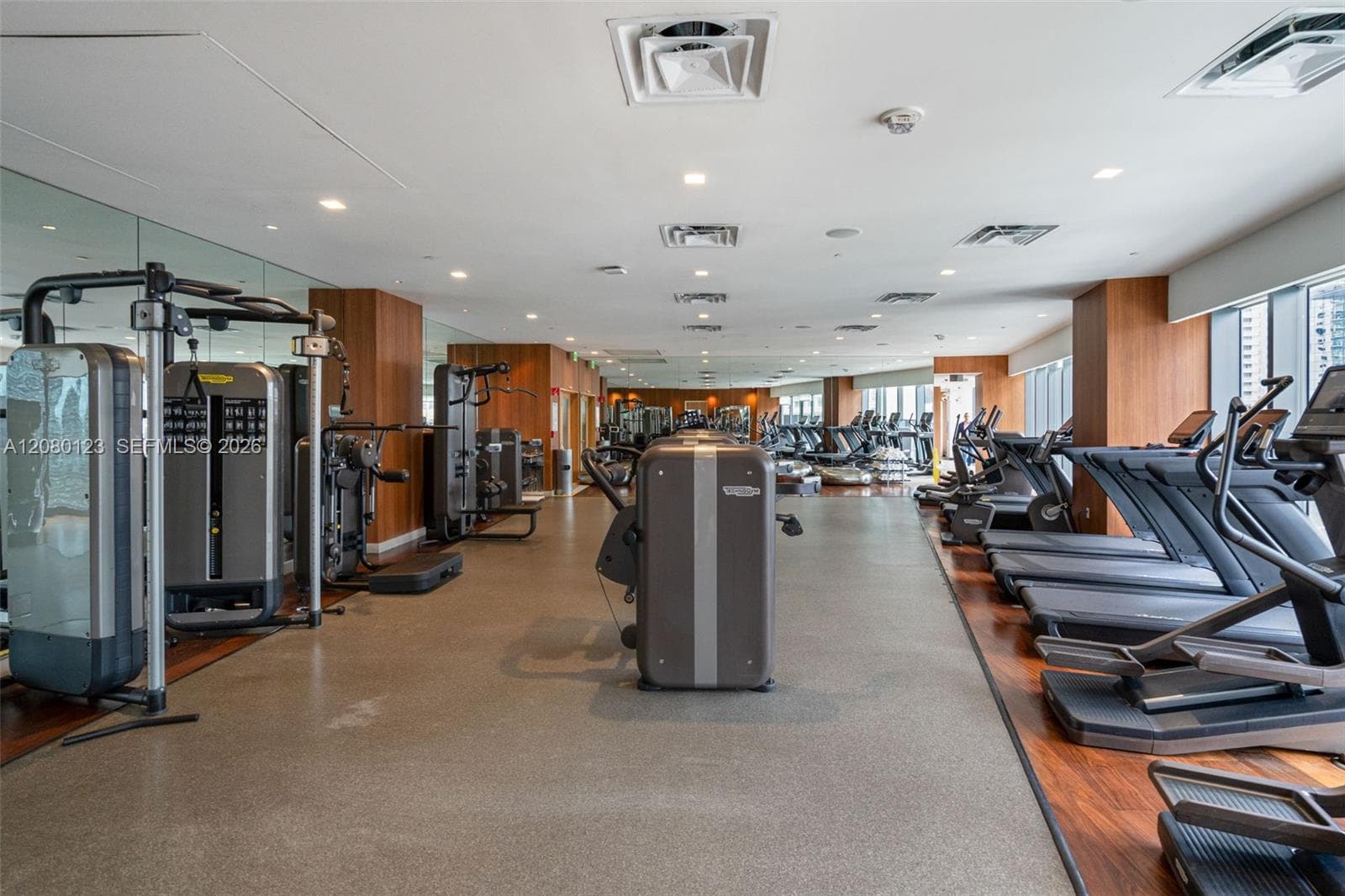 State-of-the-art gym with cardio machines, free weights, and city views at SLS Brickell Dua.