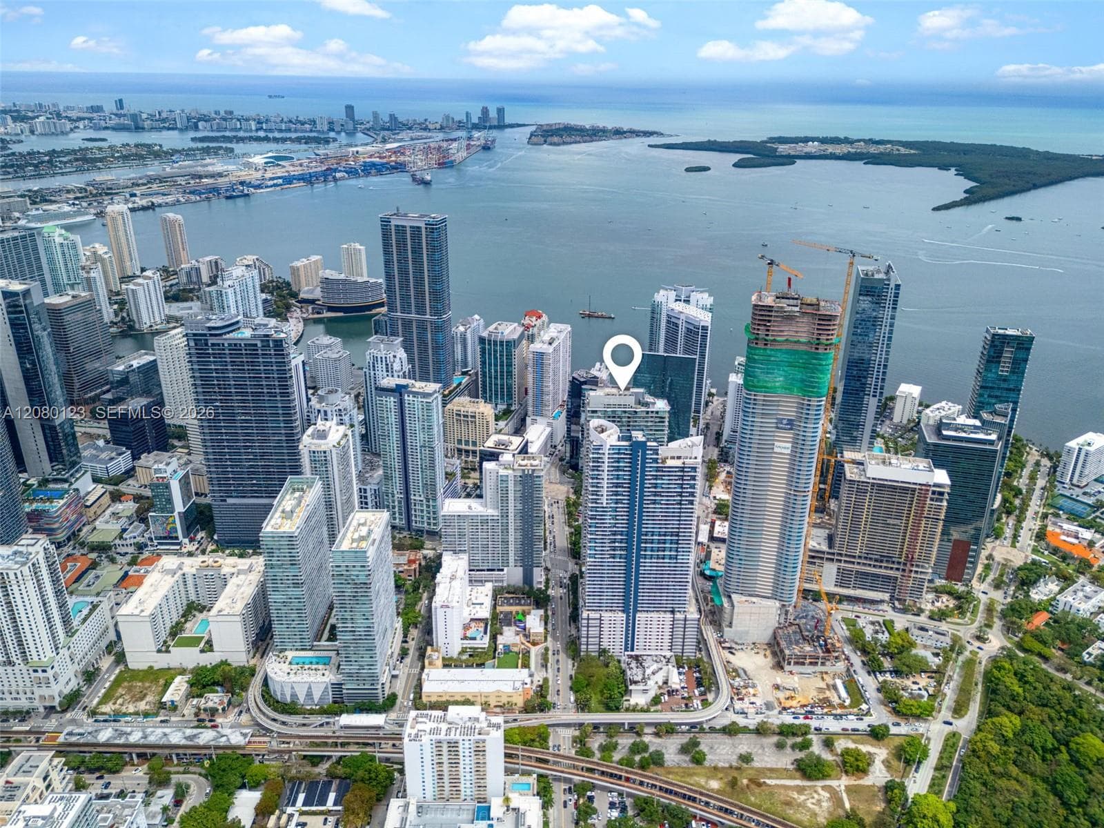 Aerial view of Brickell with Biscayne Bay and Miami Beach on the horizon - PH-5209's commanding outlook.
