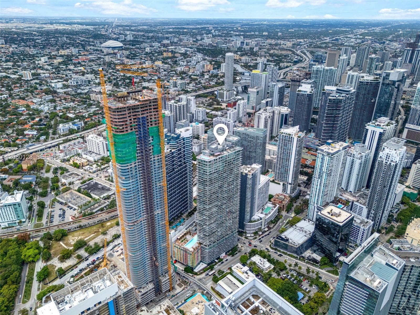 Aerial view of Miami's skyline including Brickell, downtown, and Biscayne Bay from above SLS Brickell Dua.