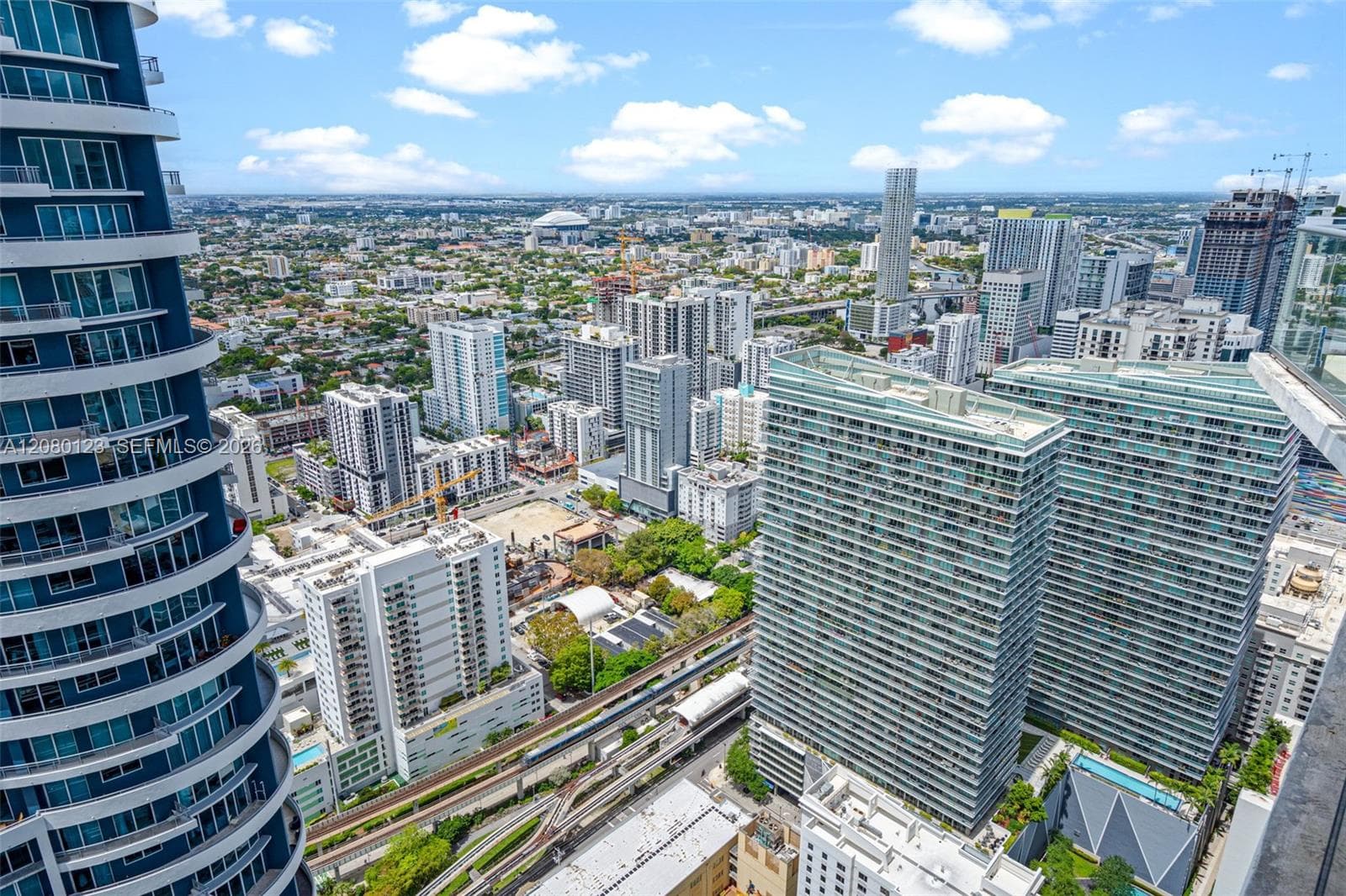 Aerial view of Brickell with Biscayne Bay and the Atlantic Ocean on the horizon - PH-5209's commanding outlook.