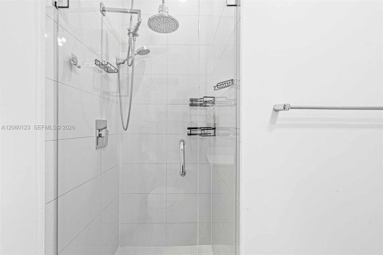 Frameless glass walk-in shower with rainfall and handheld fixtures - sleek modern design at SLS Brickell Dua PH-5209.