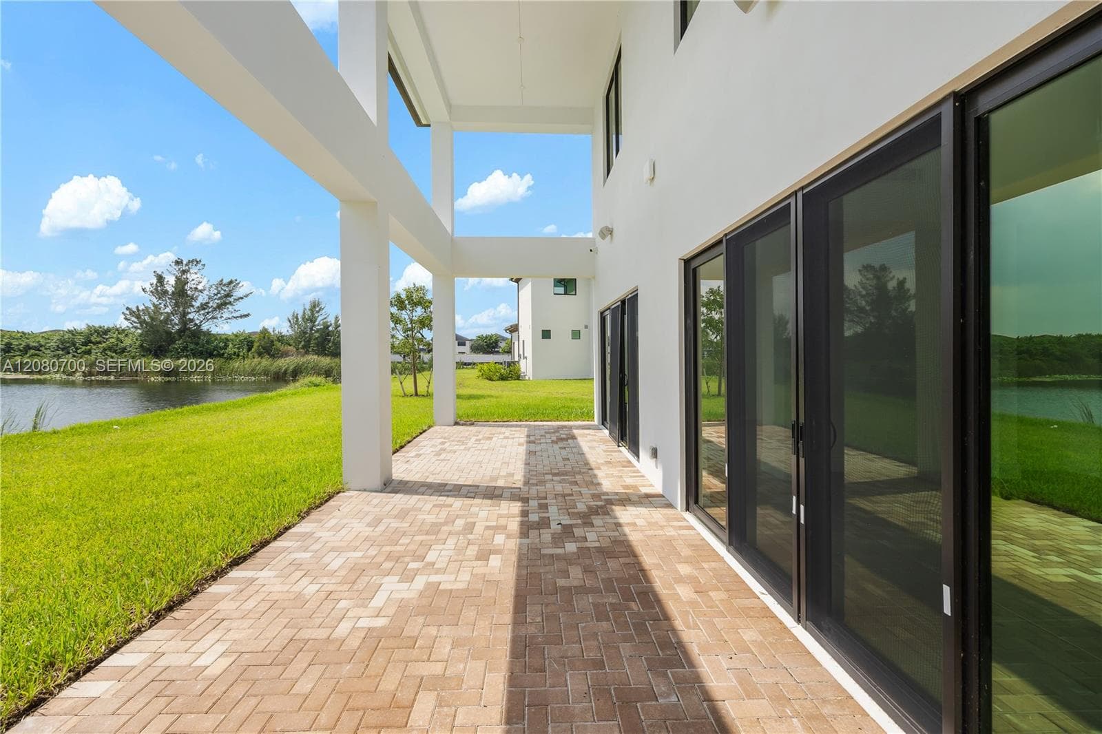 Covered patio with a herringbone brick paver surface