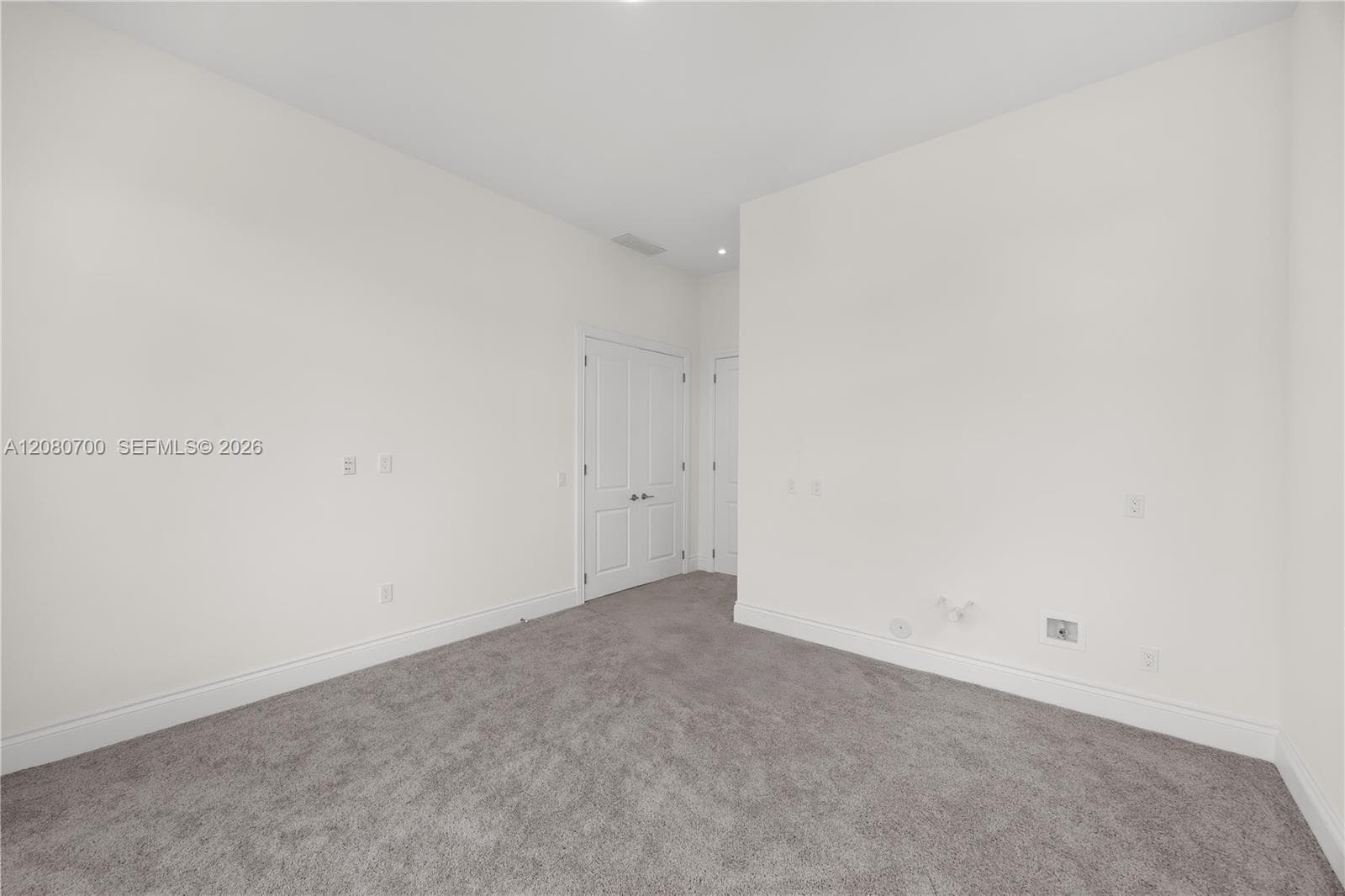 Recessed lighting, light gray wall-to-wall carpeting, and white interior doors