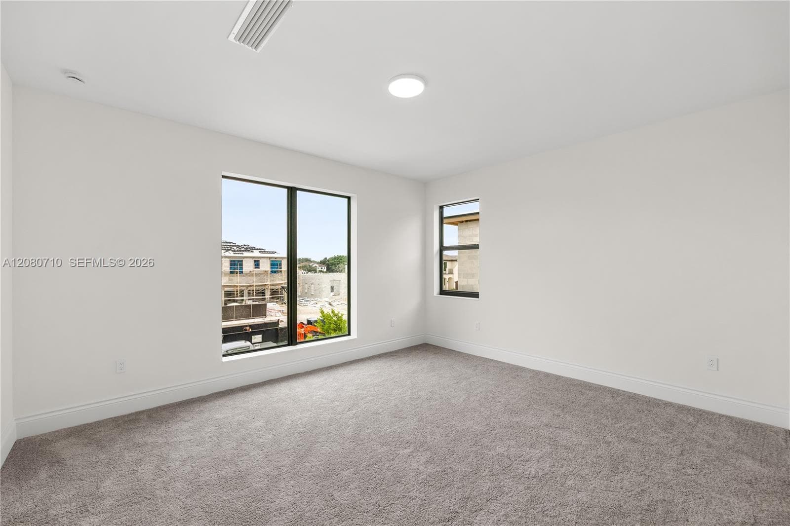 Light gray carpeting with white painted walls