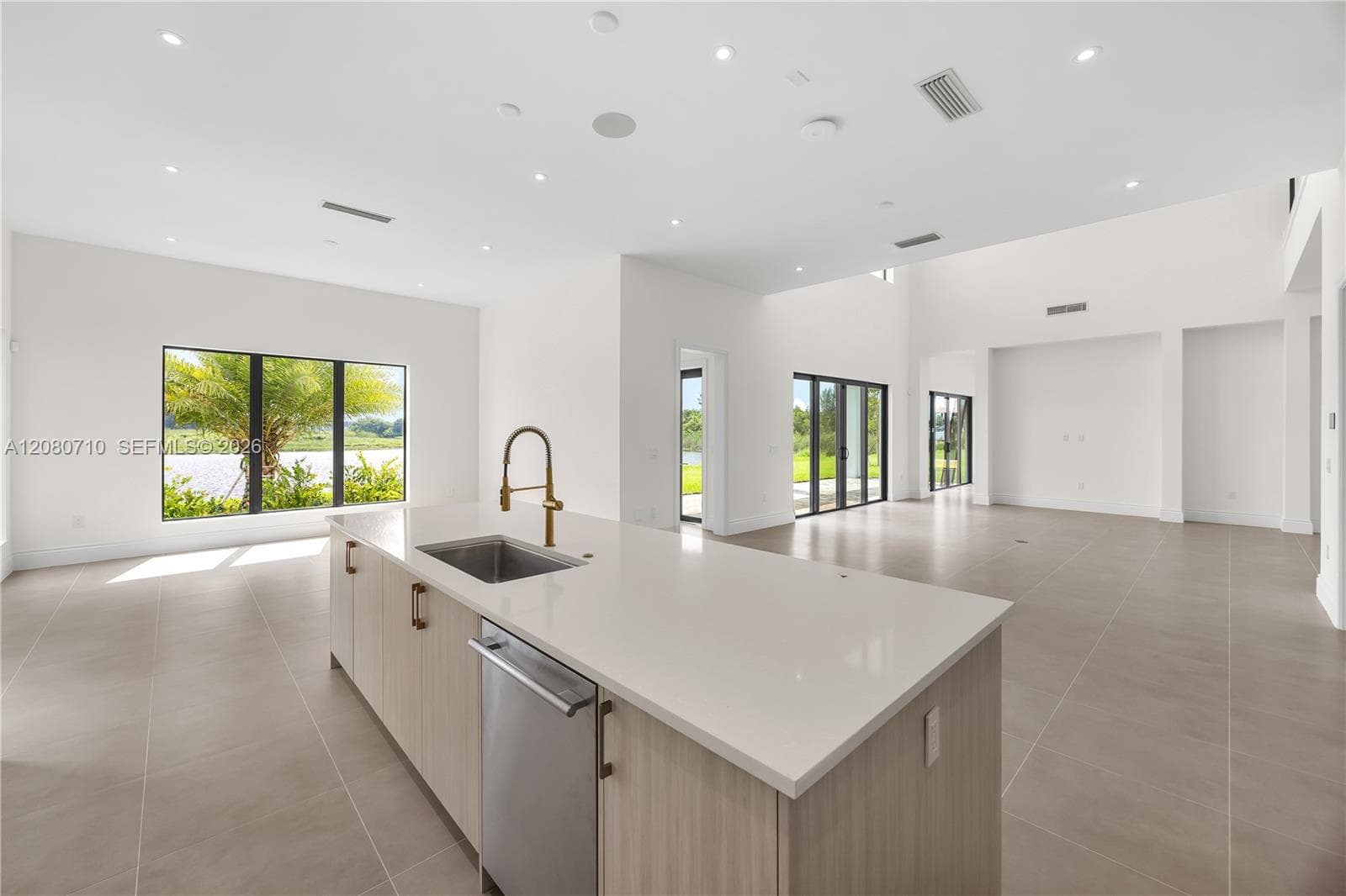 Expansive open-concept interior featuring high ceilings and large format floor tiling
