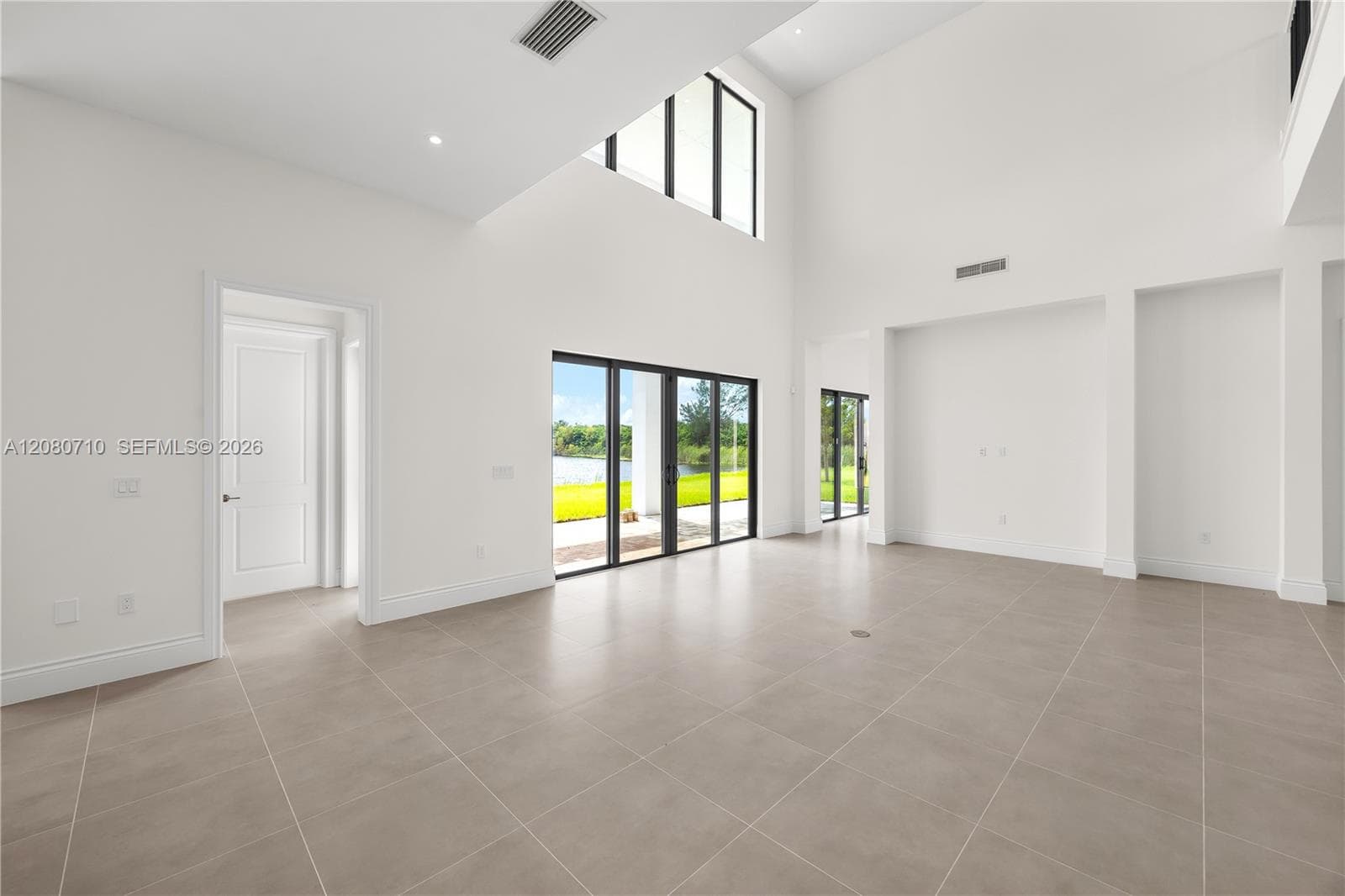 Vaulted ceilings, recessed lighting, and large format tile flooring
