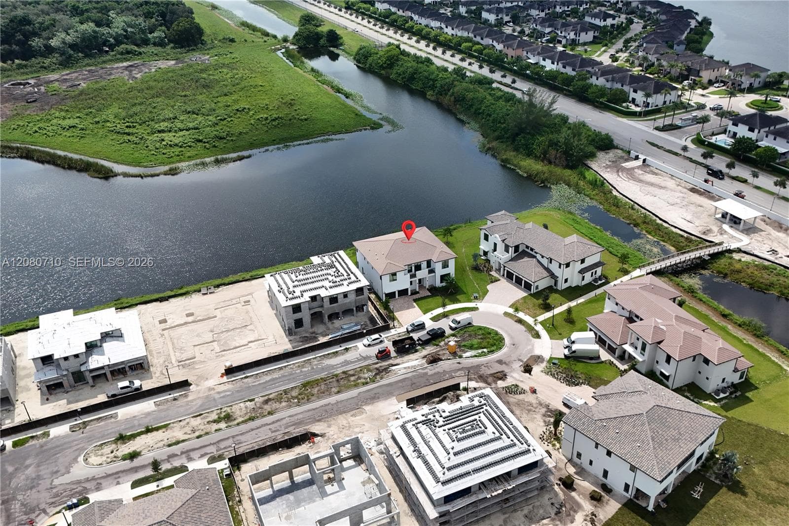 Waterfront property with a distinct architectural style and a circular driveway