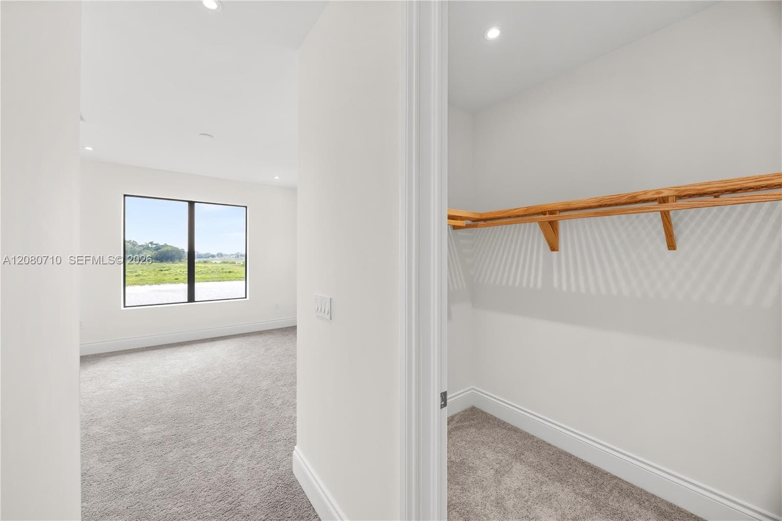 Recessed lighting, carpet flooring, and a large window