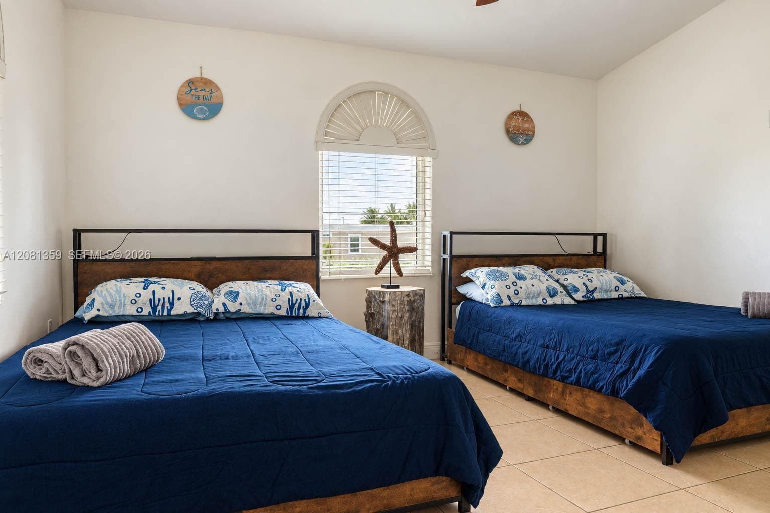 Arched window with sunburst muntins and tile flooring