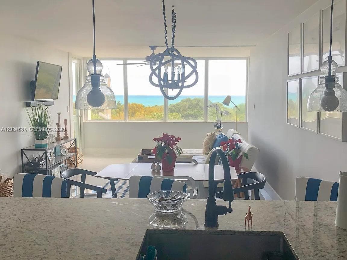 Bright, light-filled dining area anchored by expansive windows framing scenic landscape vistas
