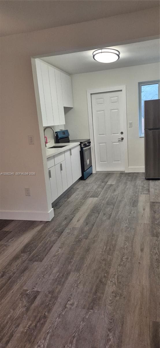 brand new kitchen and appliances. Doorway to the side patio for washer/dryer shed