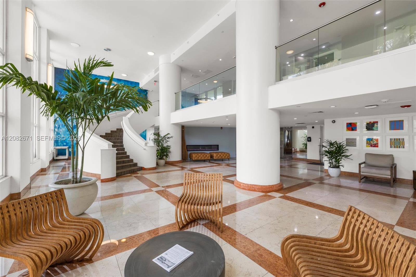 Renovated marble lobby with sculptural staircase.
