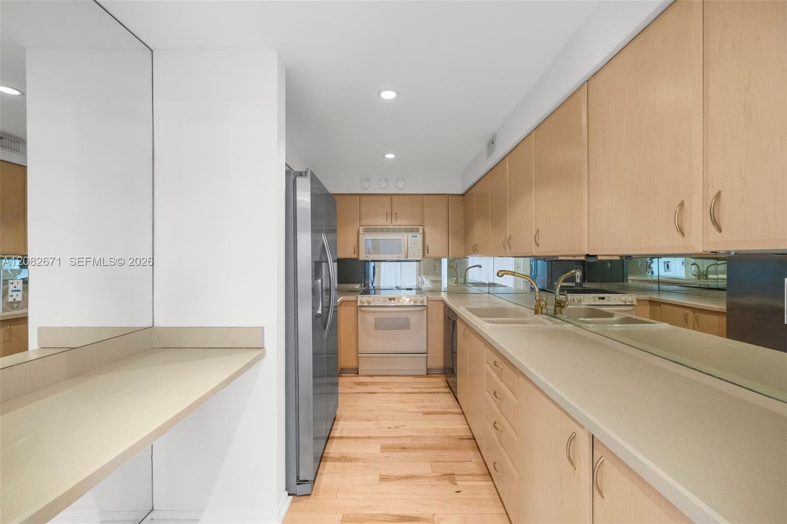 Galley kitchen with abundant cabinet storage.