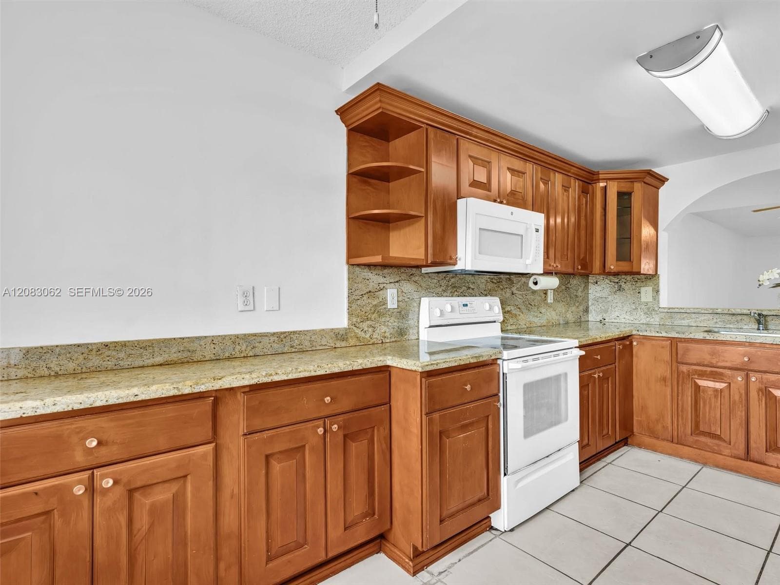Ample Kitchen, Granite Counters, and huge window brings in natural light.