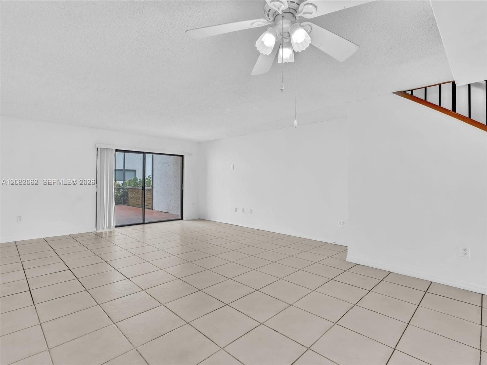 Living and Dining room combo with tile flooring and patio door slider