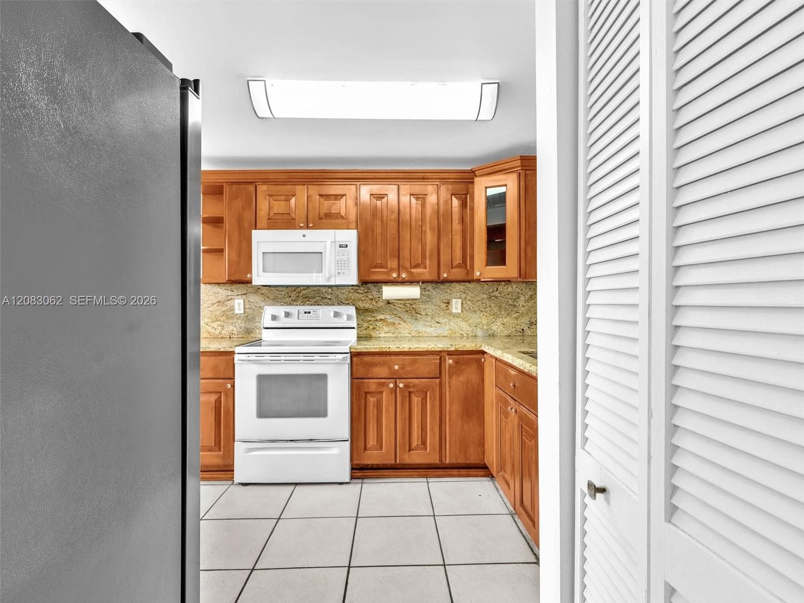 Ample Kitchen, Granite Counters, and huge window brings in natural light.